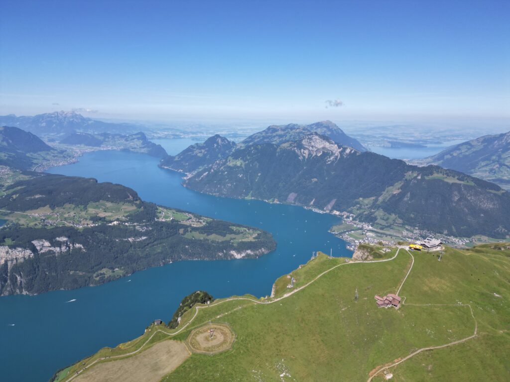 A breathtaking daytime panoramic view of Lake Lucerne surrounded by mountains from the Fronalpstock viewpoint.